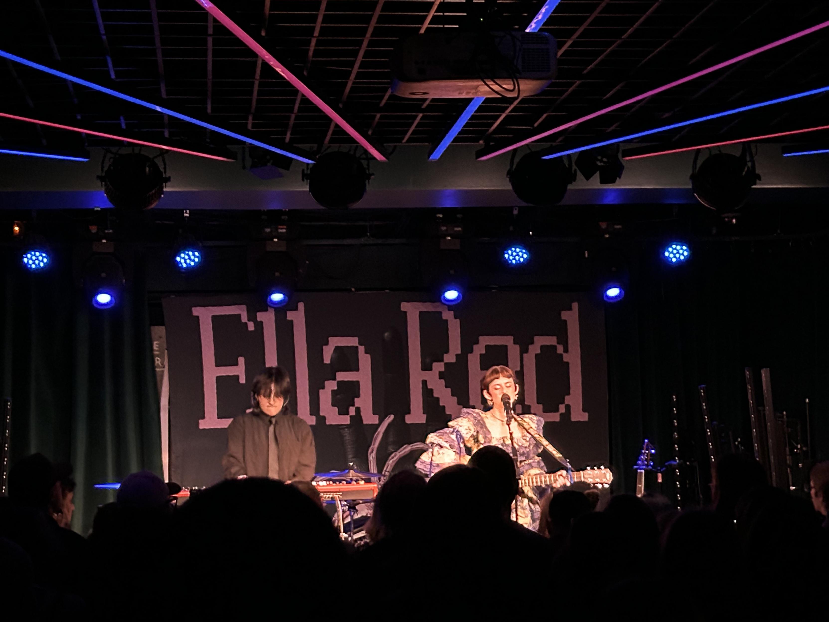 PEGGY on stage playing guitar
